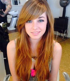layered red hairstyle with long side bangs