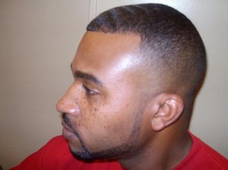 A black male with a fresh fade haircut