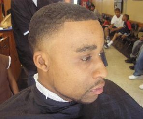A black man with a low fade haircut